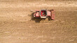 Aerial view combine, harvester, harvesting on sunflower field. Mechanized harvesting sunflower.