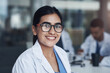 Portrait, group and woman in meeting, doctor and healthcare with medicare, glasses and employee. Face, person and medical with professional, confidence and pride with career ambition, joyful or smile