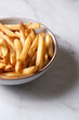 © Austockphoto - Bowl of hot chips on marble table