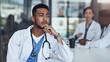 © peopleimages.com - Thinking, male doctor and hospital for healthcare, physician and medical health staff. Professional, expert and surgeon with stethoscope, man person or cardiologist for case research with colleagues