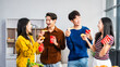 © NanSan - .Young Asian students gather with friends for a pizza party, laughing and sharing slices. Enjoying fast food delivery, they embody diversity and togetherness in a relaxed, enjoyable lifestyle.