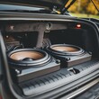 © Natalia - Installation of a custom subwoofer in a car trunk, focus on power and audio quality