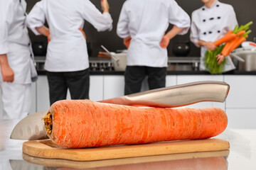 Wall Mural - Peeled sweet carrots on the table in the restaurant kitchen.