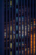 Skyscraper glass facade reflecting at night