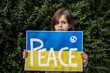 Young advocate for peace in a time of conflict. A plea for ceasefire and solidarity reflects hope for resolution.