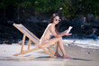 Sexy woman with bikini used applying sun cream on body is sun block skin protection and body care cream on beach summer holiday vacation .	