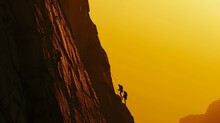 Rock Climbers Ascending Sheer Cliff At Dawn With Dramatic Lighting And Scenic Landscape