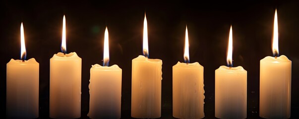 Poster - Illuminated row of candles on dark background