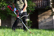 Man mowing grass with a string trimmer