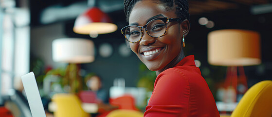 Wall Mural - A woman wearing glasses and a red shirt is smiling at the camera
