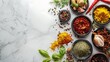 Various Spices, Herbs and Condiments on white stone table, top view, copy space, Healthy cooking, indian food background