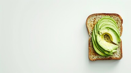 Wall Mural - Avocado slices on toast against a white background.