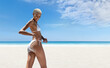Hot summer holiday, woman on the beach wearing a bikini with sand on her buttocks. Against the panoramic seaside background. Concept of online shopping, skincare protection, travel and resort booking