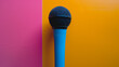 Blue microphone against a pink and yellow background.