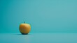   An orange sits atop a table against a blue backdrop A green apple rests in the image's center, hovering above the orange