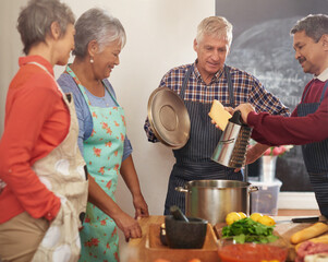 Wall Mural - Cooking, dinner and mature people in kitchen learning recipe for healthy diet, nutrition and wellness. Culinary, retirement and men and women with ingredients, vegetables or food for supper together