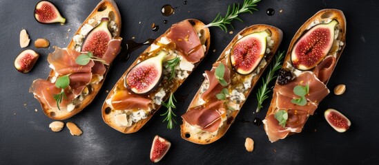 Poster - Four bread slices with figs and cheese on black surface