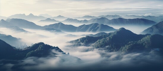 Sticker - Mountains shrouded in mist under a clear blue sky