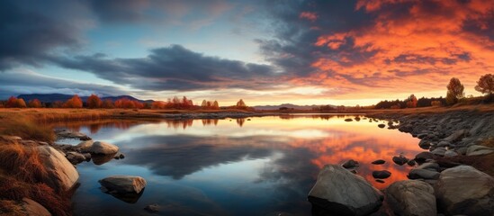 Poster - Peaceful river with rocks under a calming sunset