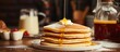 © Ilgun - Stack of delicious pancakes topped with butter and syrup