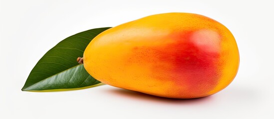 Poster - A ripe mango with a green leaf on a plain surface