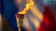 © alphaspirit - Close-up of the olympic torch lit with a vibrant flame, representing the spirit of the games