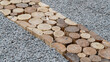 Construction of a decorative walkway pavement  from natural  wooden stamps.