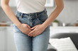 Woman suffering from cystitis at home, closeup