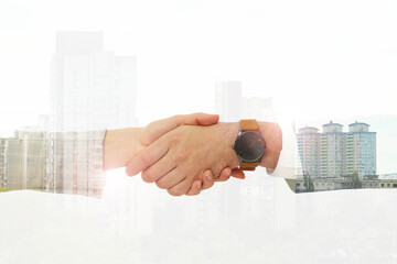 Wall Mural - Double exposure of cityscape and partners shaking hands on white background, closeup