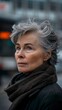 © Vagner Castro - Portrait of a 60-year-old woman with short gray hair, displaying a mix of grace and determination. Woman with a serene and wise look in a blurred setting.