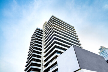 Wall Mural - Low angle view of Jakarta city building corner against clear blu sky.