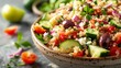 Freshly prepared Mediterranean Quinoa Salad close-up, with succulent tomatoes, cucumbers, red onion slices, olives, and crumbled feta, in raw style with studio lighting on an isolated backdrop
