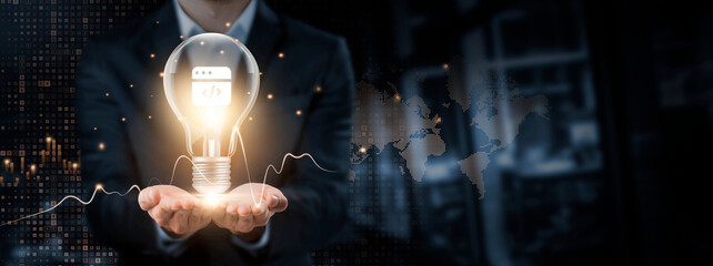 Wall Mural - web development: creativity, future-forward concept. hands of businessman holding light bulb and web