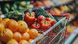 Close up of a shopping cart in a supermarket brimming with healthy fruits and vegetables