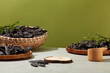 Black locust theme with empty wooden podium for displaying product on light gray table over moss green background. Front view photo with blank space for designing