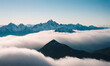 Beautiful landscape of snowy mountain peaks above the clouds.