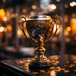 Golden trophy cup on table in cafe with bokeh background.