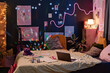 No people wide interior shot of laptop and copybooks on bed in modern teenagers bedroom decorated with posters and lamps, copy space