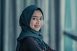Young asian muslim woman in head scarf smile with arms crossed