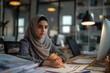 Muslim businesswoman in hijab works on engineering and e commerce.
