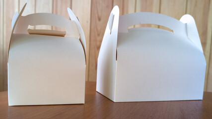 Takeaway two blank mock up cake carton Boxes tasty white box for mockup design empty brand text on wooden indoor Background