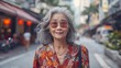 An elderly woman with white hair and stylish clothes. Smiling happily in the middle of a big city. It represents a happy later life. Suitable for savings campaigns or for advertising life insurance.