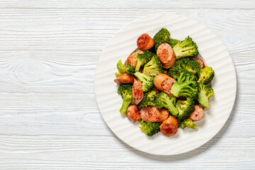 Canvas Print - fried juicy sausage and crispy broccoli on plate