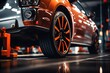© Creative - Car wheel in auto repair shop. Auto service industry. Car service.