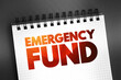 Emergency fund - personal budget set aside as a financial safety net for future mishaps or unexpected expenses, text on notepad