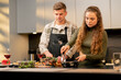 young couple in love in a beautiful kitchen preparing dinner together happy relationship