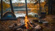 Near a camping tent in the forest, a beautiful bonfire burns with firewood, surrounded by chairs, creating a cozy campsite atmosphere.