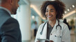 © Maksym - A close-up of a female doctor in a bright hospital lobby, her gentle smile indicative of empathy and understanding as she discusses healthcare plans on a tablet with a man in a bus