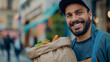 A close-up shot of a food delivery man's confident smile as he collects a bag of freshly prepared meals from the cafe staff, ready to embark on his journey to bring culinary satisf