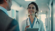 © Maksym - Close-up of a female doctor in a bright hospital hallway, her subtle smile conveying professionalism and approachability as she shares diagnostic findings on a tablet with a man in
